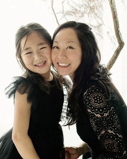 Dr. Cindy Chay cheek to cheek with her smiling daughter